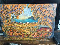 Full view of landscape painting in black frame