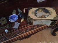 Photo showing assortment of pipe, Thornes tin with Victorian art lid, metal openers, decorative metal birds, ceramic knob and miniature plate.