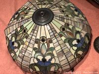 Top-down view of stained glass shade showing floral motif pattern