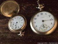 Two Waltham pocket watches side by side, open-face Arabic dial and hunter-case Roman dial