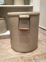 Side view of the large ceramic pot showing wooden handle and patent date marking Dec 29 1914