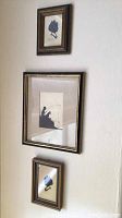 Set of three framed vintage silhouette pictures hanging on a wall.