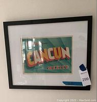 Front view of the framed art print with "Greetings from Cancun Mexico" design in bright colors.