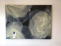 Front view of the large enameled canvas wall art showing close-up white roses with dark background.