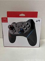 Front view of the game controller box showing the product image and red/white branding