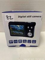 Front of the product box showing digital still camera image with specs 30.0MP, 1080p Full HD, SD card compatibility, 8x digital zoom, built-in flash