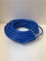 Coiled blue Cat 6 Ethernet cable approximately 50 feet long secured with twist tie.