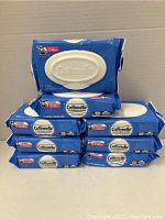 Eight blue packs of Cottonelle Flushable Wipes stacked, each containing 42 wipes, showing the front of the packaging with a white flip-top dispensing lid.