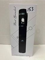 Front view of the box packaging of the Best Grinder Automatic Herbal Grinder & Dispenser, showing a black cylindrical device image and brand details.