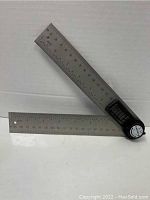 Photo of the digital angle ruler showing two stainless steel rulers connected by a digital angle gauge at the pivot point.