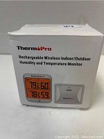 Photo of the ThermoPro branded box showing the product image and features including rechargeable wireless indoor/outdoor humidity and temperature monitor