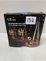 Box of LE LED Wine Bottle Cork Light showing product image of illuminated wine bottles with LED cork lights inside.
