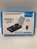 Front of box showing the Professional Digital Mini Scale TL-series model. Shows image of scale, calibration weight, and weighing modes.