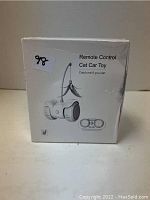 White boxed remote control cat car toy with image of the toy featuring wheels, a feather on a pole, and a remote controller printed on packaging.