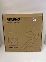Photo of the Renpho Smart Scale in original brown packaging with branding and product illustration on front.