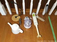 Wide view of all items including immersion blender, frother, mini chopper, teapot, banana stand, salt and pepper shakers.