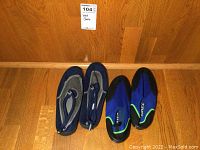 Photo showing both pairs of water shoes side by side on the floor for size and condition comparison