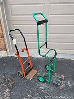 Two metal dollies in front of garage door showing front and side views