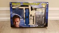 Front view of the Conair Men's Travel Grooming Set box showing the trimmer and included accessories.