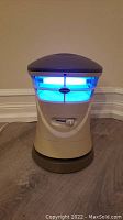 Front view of electric mosquito trap showing blue light emission.