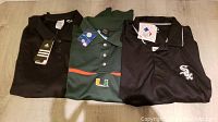 Full view of three folded men's golf shirts: black Adidas, green University of Miami, black Chicago White Sox.