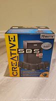 Front view of the Creative SBS 5.1 560 70 watts speaker system box showing branding and product image.