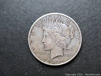 Obverse side of 1922 U.S. Silver Peace Dollar showing Lady Liberty with visible wear and the date 1922.