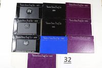 Original cardboard sleeves labeled with years for ten U.S. proof sets: 1977, 1978, 1979, 1980, 1982, 1983, 1984, 1985, 1986, 1987.