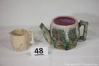 Full shot showing both Etruscan Majolica shell and seaweed pieces - creamer and teapot side by side, highlighting size and design.