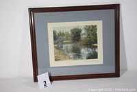 Framed photograph titled "The Swimming Pool" showing the full piece with dark wood frame and light blue matting.