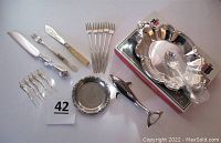 Top view of entire lot showing cutting utensils, seafood forks, cocktail picks, party set, coaster, and bottle opener arranged on surface.