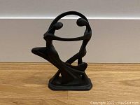 Front view of the abstract couples dance sculpture showing the flowing forms and base.