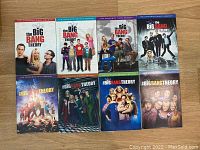 Front view of all eight DVD boxes for The Big Bang Theory Seasons 1 to 8 showing cover art with main cast, arranged in two rows of four.