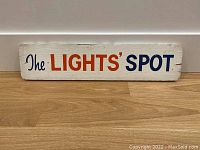 Full front view of the vintage wooden sign showing the entire painted text and weathered surface.