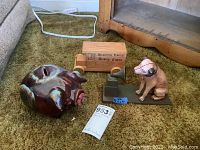 Photo of all three items together showing the wooden Reading Eagle truck, ceramic piggy bank, and cast metal dog with Victrola figurine.