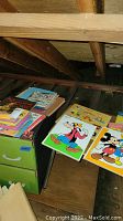 Table top showing Disney character puzzles: Goofy and Mickey Mouse with Donald Duck, and a stack of children's books.