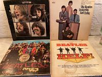 Front covers of four vintage Beatles vinyl albums displayed: Let It Be, Yesterday and Today, Sgt. Pepper's Lonely Hearts Club Band, and Help!