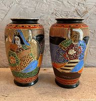 Pair of two vintage Japanese vases side by side, showing full front designs