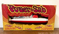 Front view of the Kenner Power Sub toy in original box showing the toy, fuel pellet packet, and branding.