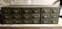 Front view of cabinet showing all 18 drawers with label pull handles