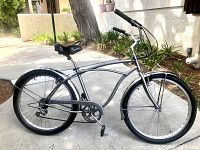 Left side profile of bicycle showing frame shape, seat, fenders and drivetrain