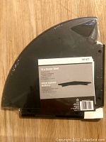 Photo of the wrapped espresso finish 12 inch quarter-circle corner shelf showing label with size and usage details