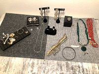 Overhead view of all jewelry items arranged on fabric background