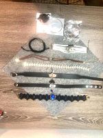 Overhead view of all items arranged on wooden surface and gray mat, showing chokers, bracelets and earrings.