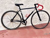 Side view of entire bike leaning against wall