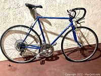 Full side view of vintage blue CALOI 10 RACER road bicycle showing frame, drivetrain and wheels.