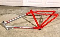 Side view of the Schwinn Circuit aluminum bike frame, showing color and frame condition with red and silver paint and Schwinn branding