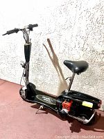 Full left-side profile of scooter with seat raised and stem upright