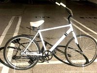 Side view of white Solé cruiser bike showing frame, wheels, and components