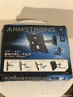 Box front showing Armstrong brand and main features: fits 17-42 inch TVs, swivel, tilt wall mount, VESA compliance
